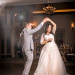 Bride and groom sharing their first dance in an elegant reception venue